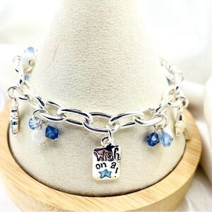 silver-tone charm bracelet featuring a central rectangular charm